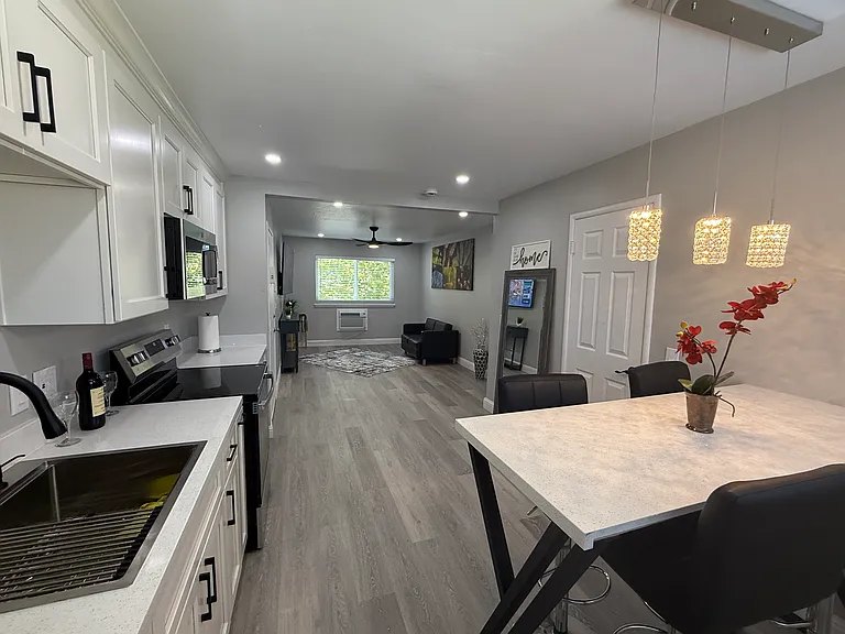 Open kitchen and living area with pendant lighting