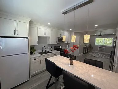 Updated kitchen with white cabinets and breakfast bar