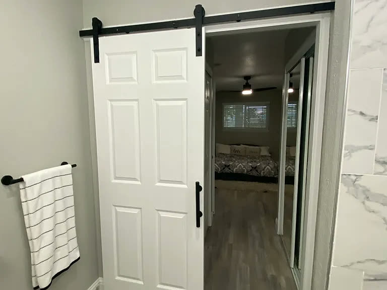 Sliding barn door leading to the bedroom