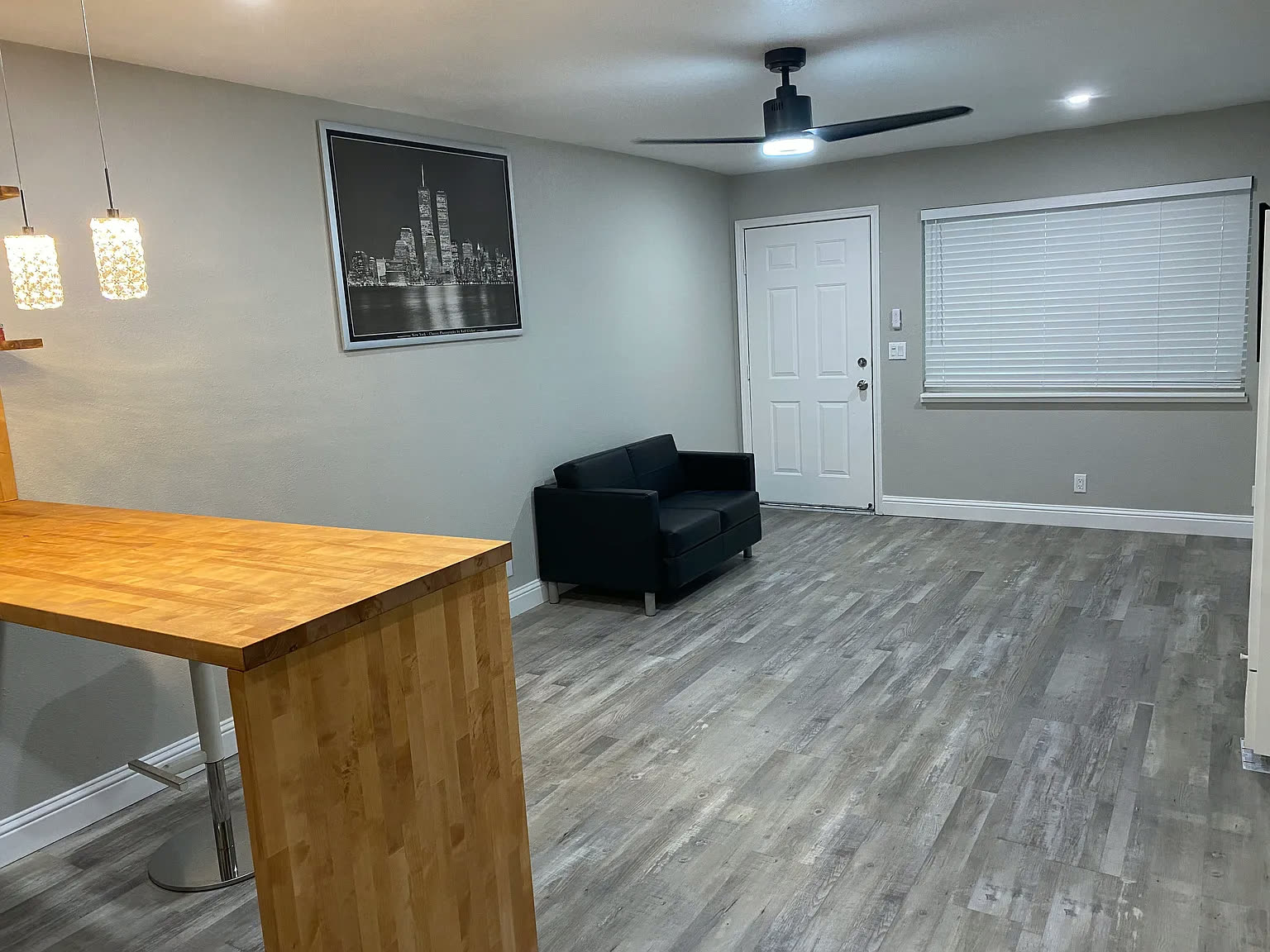 Open living room with ceiling fan and breakfast bar